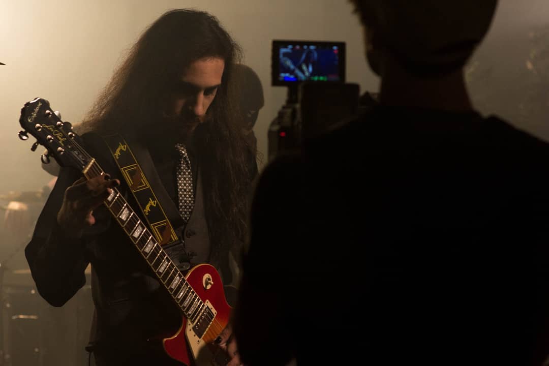 Dante on guitar.⁣ ⁣Behind the scenes of "Deliverance" music video.⁣⁣ Photo: Alek...
